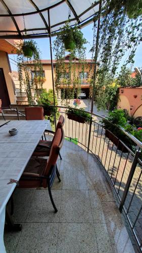 a patio with a table and chairs and a fence at Pensiunea Select in Arad