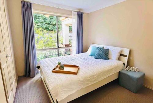 a bedroom with a bed with a tray on it at family friendly 4 bedroom house close to parks in Gold Coast