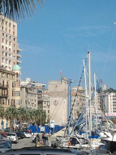 a boat docked in a harbor in a city at Appartamento Piazzetta La Maddalena in Savona