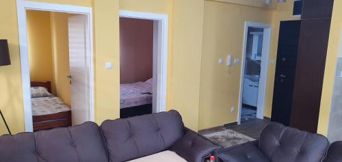 a living room with a couch and a bedroom at Apartman Banja Koviljaca in Banja Koviljača