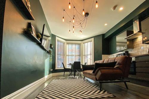 a living room with a couch and a table at Velveteen by The V Group in Blackpool