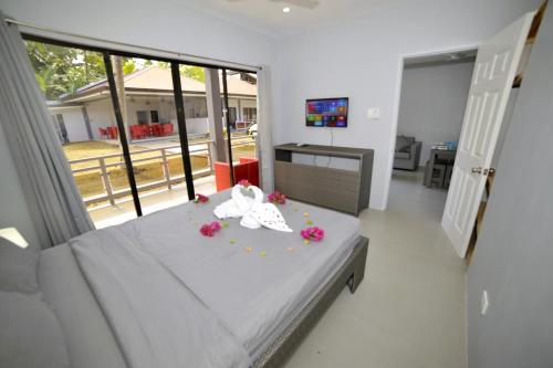a bedroom with a bed with flowers on it at ANGEL'S DREAM RESIDENCE in Panglao
