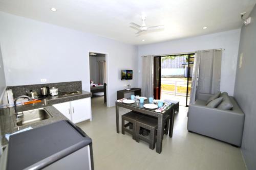 a kitchen and living room with a table and a sink at ANGEL'S DREAM RESIDENCE in Panglao