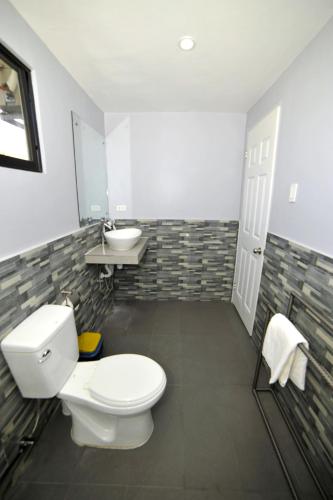 a bathroom with a toilet and a sink at ANGEL'S DREAM RESIDENCE in Panglao