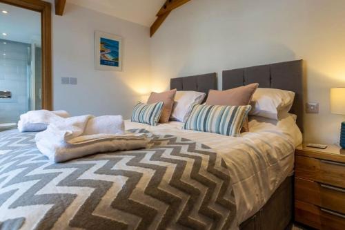 a bedroom with a large bed with a wooden headboard at 15 The Crescent - Bude Cornwall in Bude