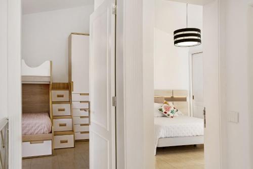 a small bedroom with a bed and a mirror at Casa el Quijote in San Bartolomé de Tirajana