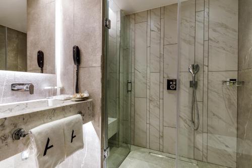 a bathroom with a shower with a glass door at Hotel Amira Istanbul in Istanbul