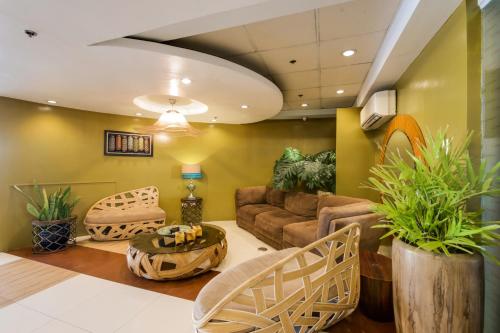 a living room with a couch and a table at Festive Hotel in Manila