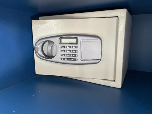 a microwave oven with its door open on a blue wall at Chez ADAC in Sidi Bou Saïd