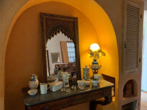 a dressing table with a mirror in a room at RIAD CHANT D'ETOILES tadighoust in El Hara