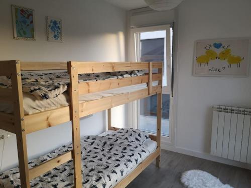 a bedroom with two bunk beds in a room at Casa de Olga & Jorge in Luanco