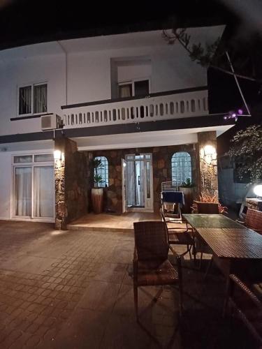 a patio with a table and chairs in front of a building at Oceanpride Complex in Flic-en-Flac