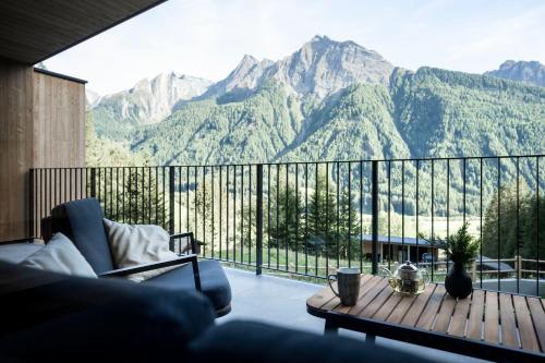 a living room with a view of mountains at Stelza Nature Chalet in Val di Vizze