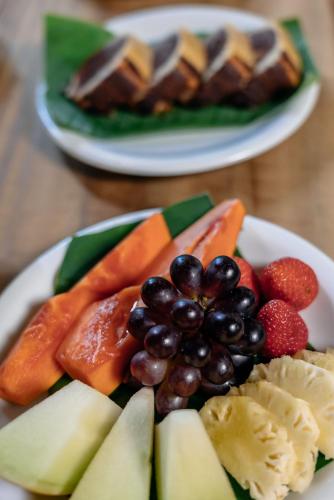 two plates of fruit and vegetables on a table at DA GRAÇA HOTEL in Trancoso