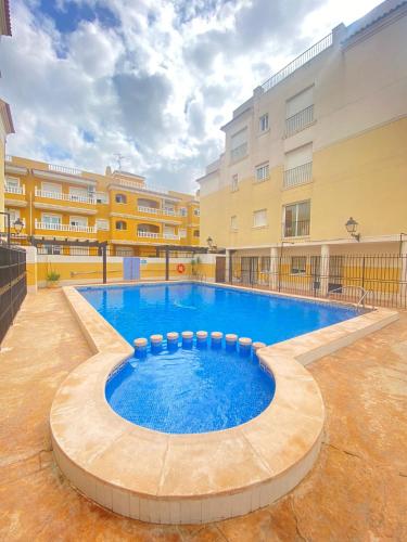 a large swimming pool in the middle of a building at S&H La Malquerida in Formentera del Segura