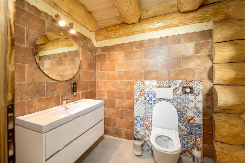 a bathroom with a toilet and a sink at Chatky JOSU in Zuberec