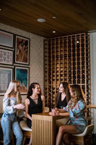 a group of women sitting around a table in a bar at Millennium Place Mirdif in Dubai