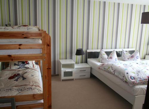 a bedroom with two beds and a bunk bed at Ferienhaus Familie Knoll in Trautenstein
