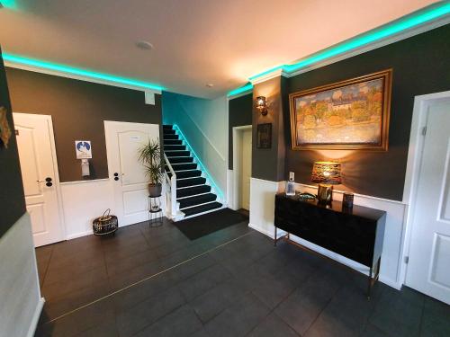 a hallway with a staircase with green lights at Gasthaus "Burgstieg" in Stiege