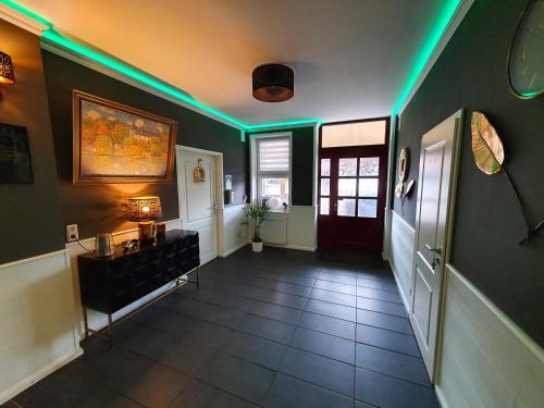 a hallway with green lights on the walls at Gasthaus "Burgstieg" in Stiege