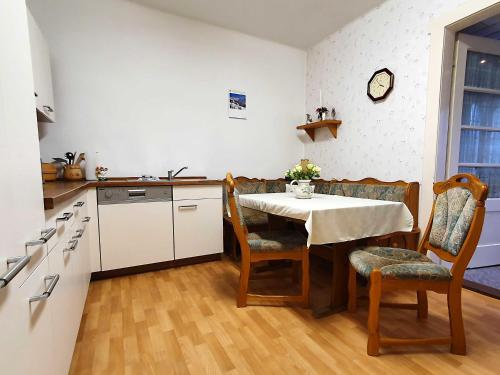 a kitchen with a table and chairs in a kitchen at Ferienwohnung Walpurga in Elend