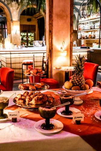 a table with plates of food on top of it at chic&basic Habana Hoose in Barcelona