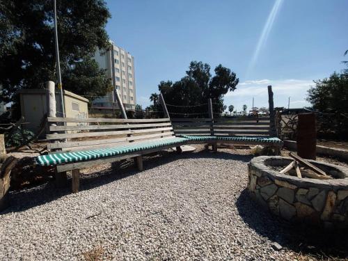 a bench in a park with a bridge at CAMP&HOSTEL Antalya in Antalya