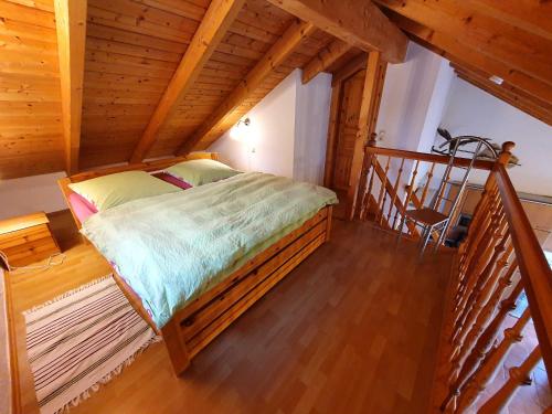 a bedroom with a large bed in a attic at Haus Irina & Haus Anna in Elend