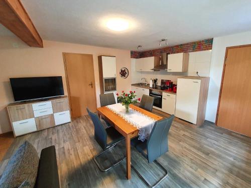 a kitchen and dining room with a table and chairs at Haus Sonja in Tanne