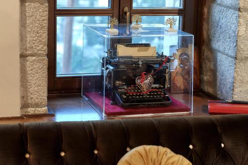 an old typewriter in a glass case in a room at Archontiko Deligianni in Dhimitsana