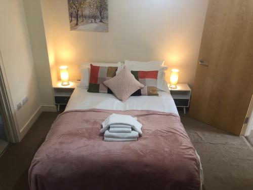 a bedroom with a bed with two towels on it at Luxury Town Centre Property with parking in Cheltenham