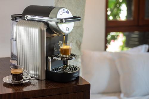 a coffee maker and two cups of coffee on a table at Alegra Boutique Hotel in Jerusalem