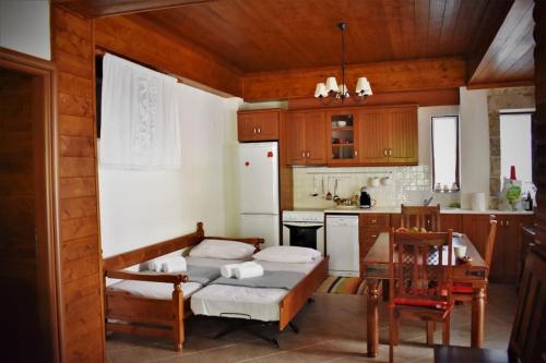a kitchen with a table and a dining room at Stonehouse dome Lagadia in Lagadia