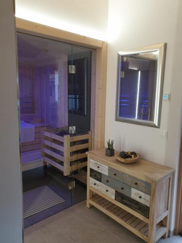 a bathroom with a wooden dresser and a mirror at Hochalmbahnen Chalets Rauris 1-06 WE2 Maislaufeldweg 1g EG in Rauris