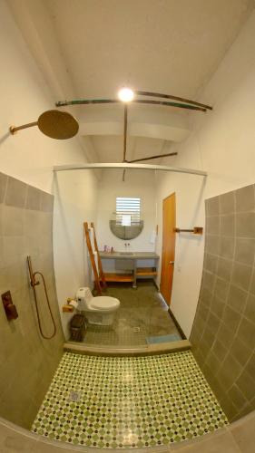 a bathroom with a shower and a toilet in it at Casa Mambo Salinas in Santa Veronica