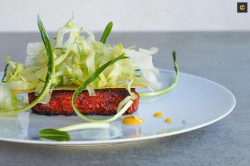 a white plate topped with a meat dish with a salad at Hotel Ristorante Da Politano in Boves