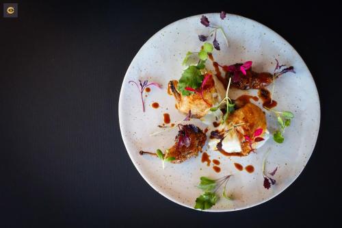 a white plate with food on a table at Hotel Ristorante Da Politano in Boves