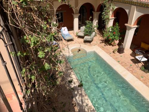 a swimming pool in the yard of a house at RIAD CHANT D'ETOILES tadighoust in El Hara