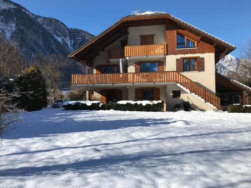 a house with snow in front of it at Le Chalet Carpe Diem in Le Bourg-dʼOisans