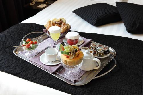 a tray with a tray of food on a bed at Holiday Inn Genoa City by IHG in Genova