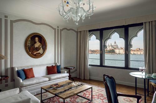 a living room with a couch and a chandelier at Hotel Cipriani, A Belmond Hotel, Venice in Venice