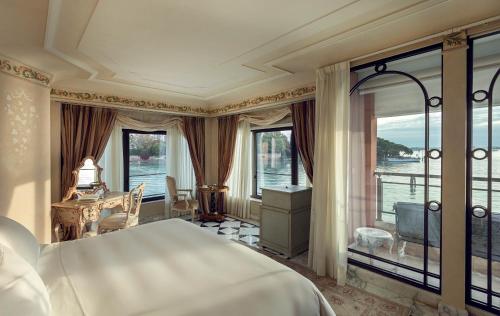a bedroom with a large bed and a balcony at Hotel Cipriani, A Belmond Hotel, Venice in Venice
