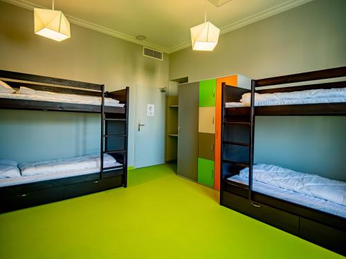 two bunk beds in a room with a green floor at BANANA'S CAMP in Cannes