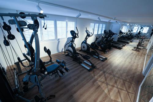 a row of exercise bikes in a gym at City Hotel Glarnerland in Näfels