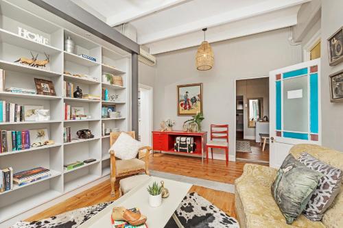 a living room with white bookshelves at La Montagne Lodge in Riebeek-Kasteel