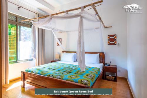 a bedroom with a bed with a canopy at Heaven Restaurant & Boutique Hotel in Kigali
