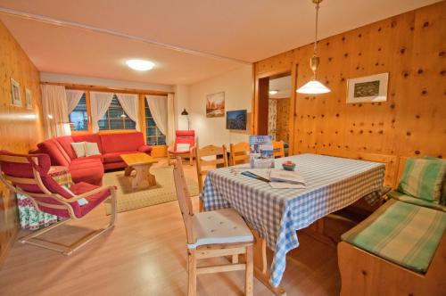 a kitchen and living room with a table and chairs at Dent Blanche in Zermatt