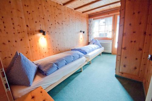 a room with two beds in a room with a window at Dent Blanche in Zermatt
