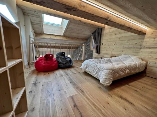 a bedroom with a bed and two bags on the floor at POLARIS Bel appartement village et pistes in La Clusaz