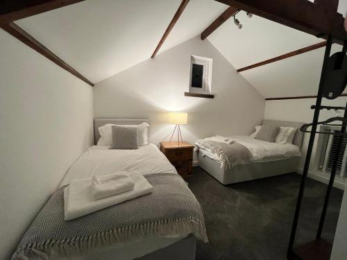 a bedroom with two beds in a attic at The Old Chapel Manton 